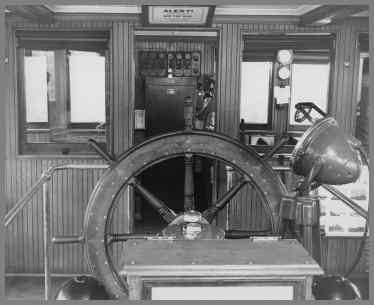Wheelhouse view showing wheel and radio in background