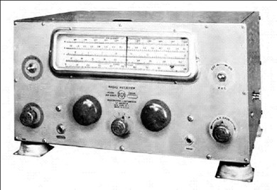 Shock-mounted radio receiver with 3 knobs, 2 tuning knobs and a slide-rule dial