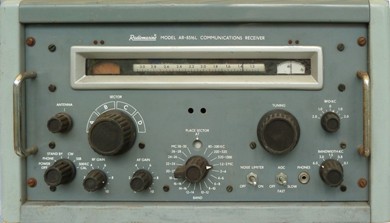 Radio receiver with 7 small knobs, 2 large knobs, a meter and slide-rule dial