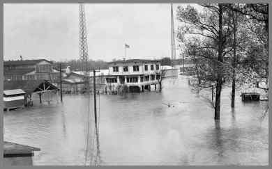 Flooded WUG2 site showing towers and frame building with water all around