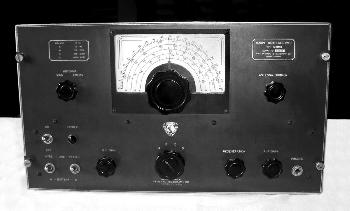 Gray tabletop receiver with a semi-circular dial and 7 knobs