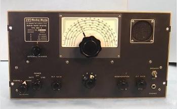 Gray tabletop receiver with a semi-circular dial and 7 knobs