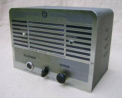 Tabletop Radio transceiver with 2 knobs and big speaker grill on front.