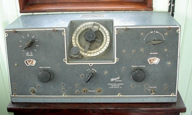Desktop unit with 5 knobs, 2 small indicator windows and the direction indicator in the front top center tilted back at a 45 degree angle.