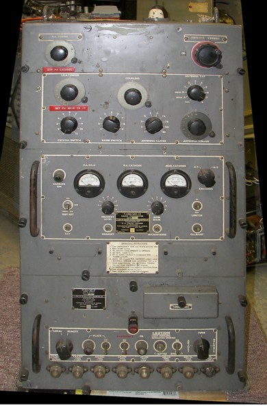 3.5 Foot high metal cabinet divided into 3 main panels, top panel with 7 knobs, midde panel with 4 knobs and 3 meters and a lower, power supply, panel with 2 fuse holders, 2 knobs, 3 toggle switches and a row of soctets for metering.