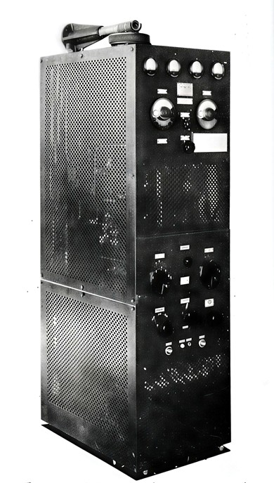 Tall cabinet with multiple knobs and meters, and much peforated metal for cooling 